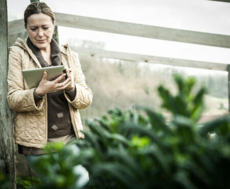 Female Farmer with Digital Tablet in Vegetable Garden